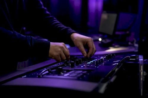 Hands adjusting cybersecurity controls in data center